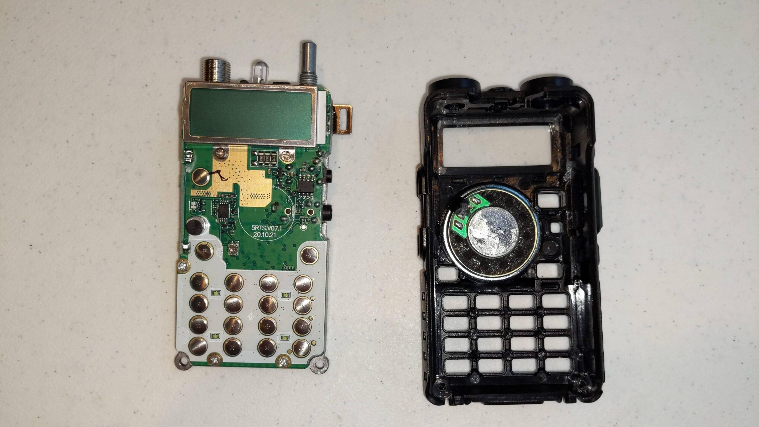 Baofeng UV5R, with internals removed from shell and speaker wire cut
